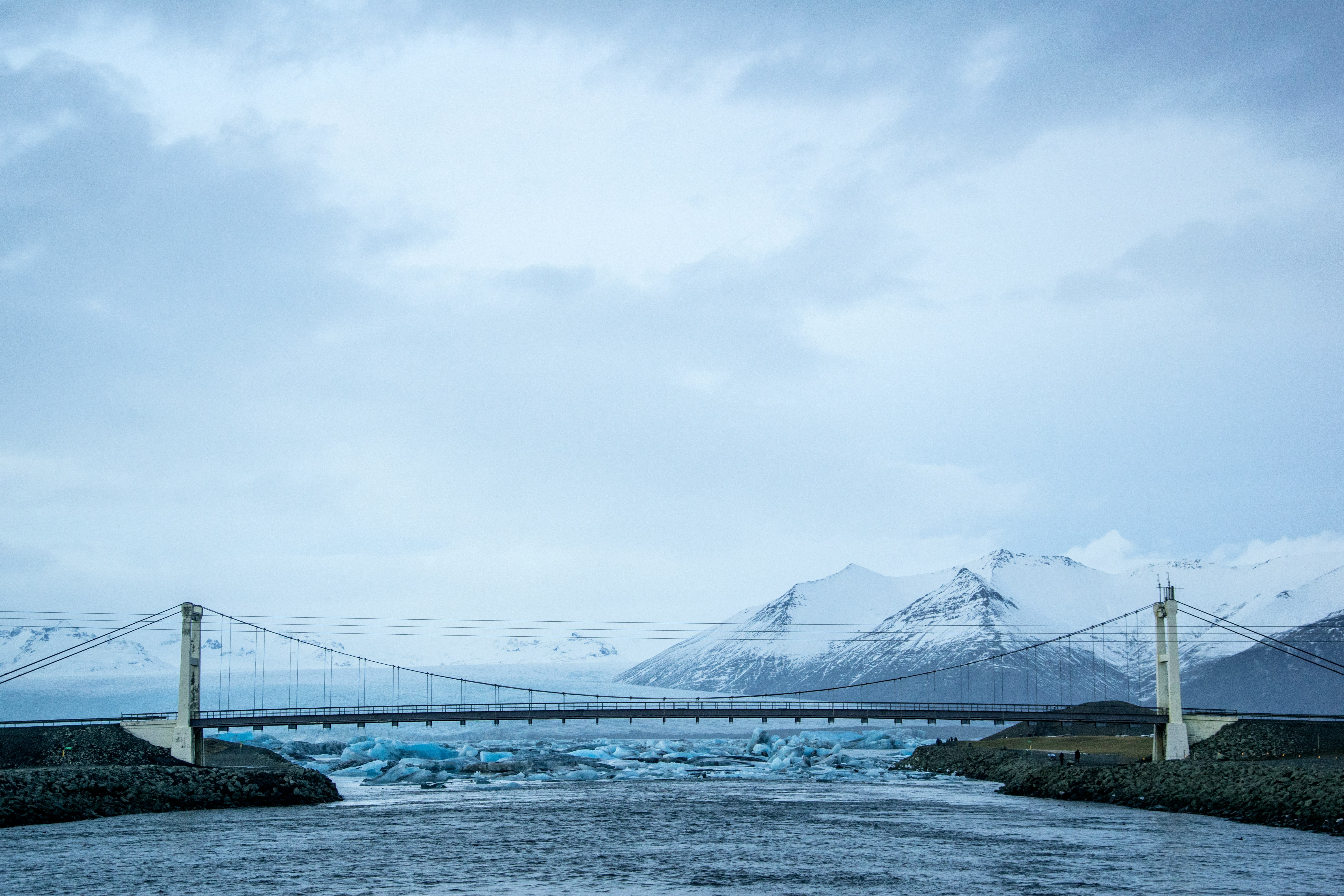 bridge over the lake under white sky